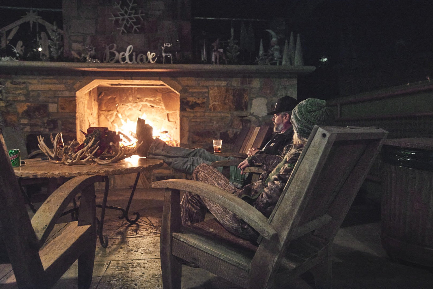 a group of hunters gather around the fireplace at Soggy Bottom Lodge at the end of an exciting day hunting in Alabama